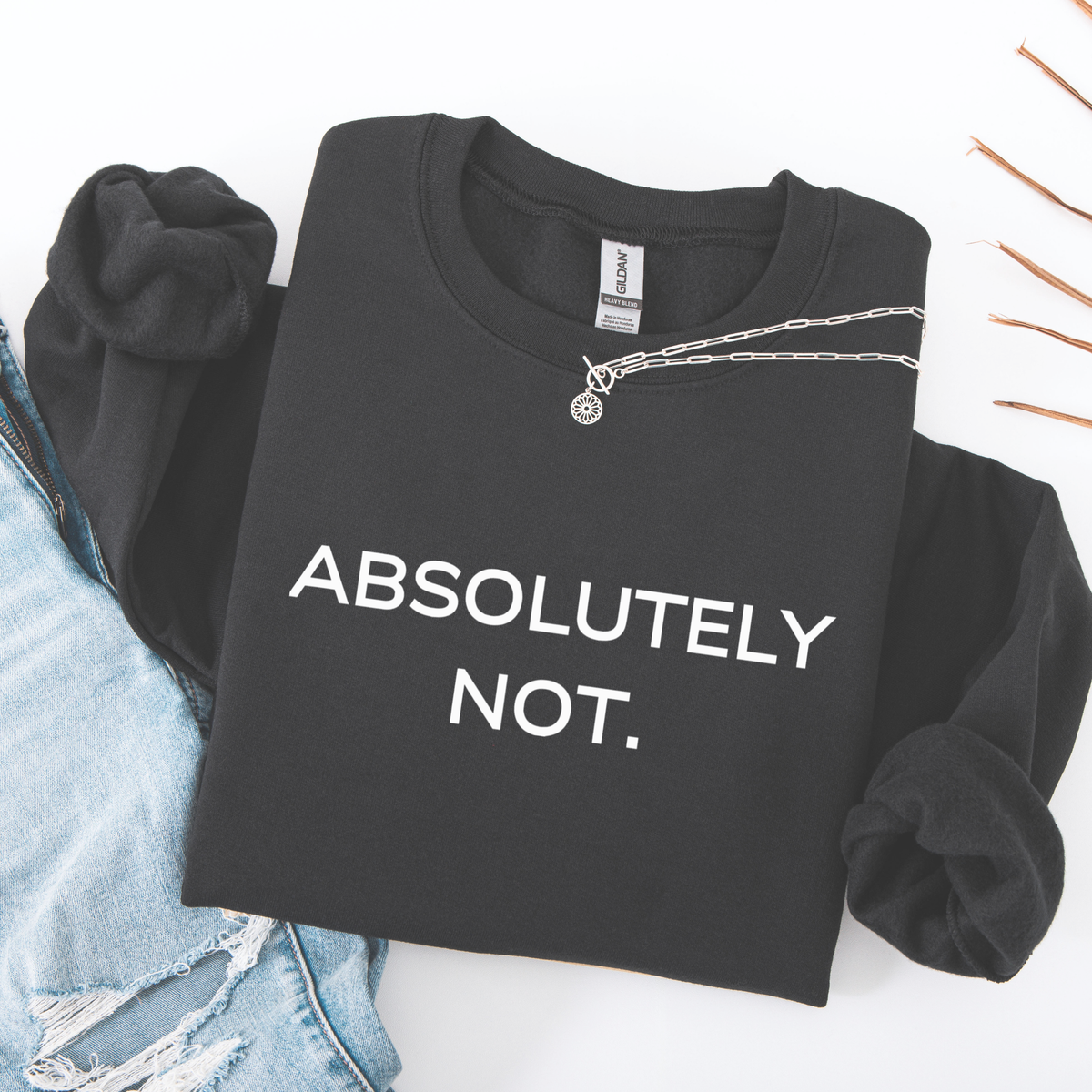 A folded Black sweatshirt with 'ABSOLUTELY NOT.' text on a white background