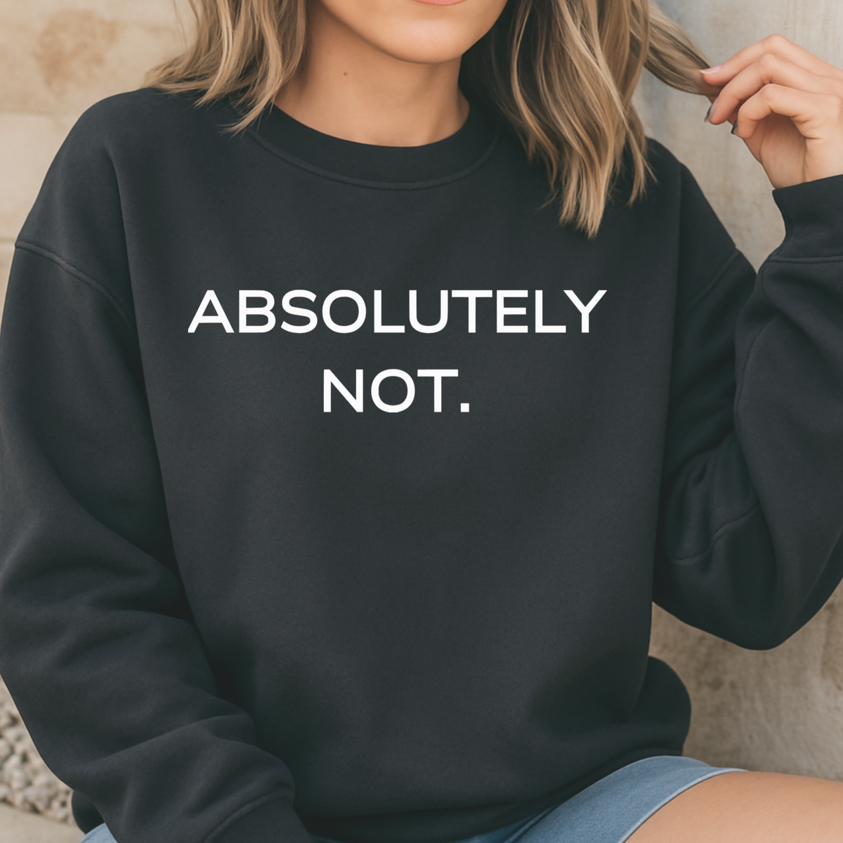 A woman wearing a black sweatshirt with 'ABSOLUTELY NOT.' text.