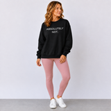 A woman modeling a black crewneck sweatshirt with the text 'ABSOLUTELY NOT.' in white on the chest, paired with dusty pink leggings and white sneakers, standing against a light gray studio background.