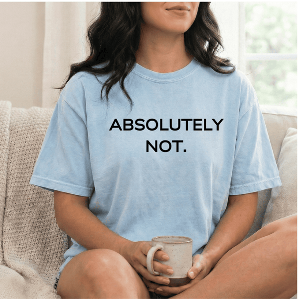 A woman wearing a light blue t-shirt with 'ABSOLUTELY NOT.' text, holding a mug.