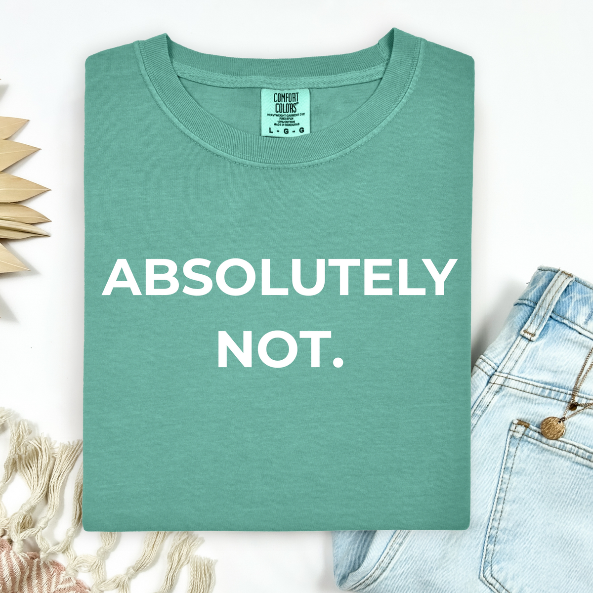 Green t-shirt with 'ABSOLUTELY NOT.' text on a white background