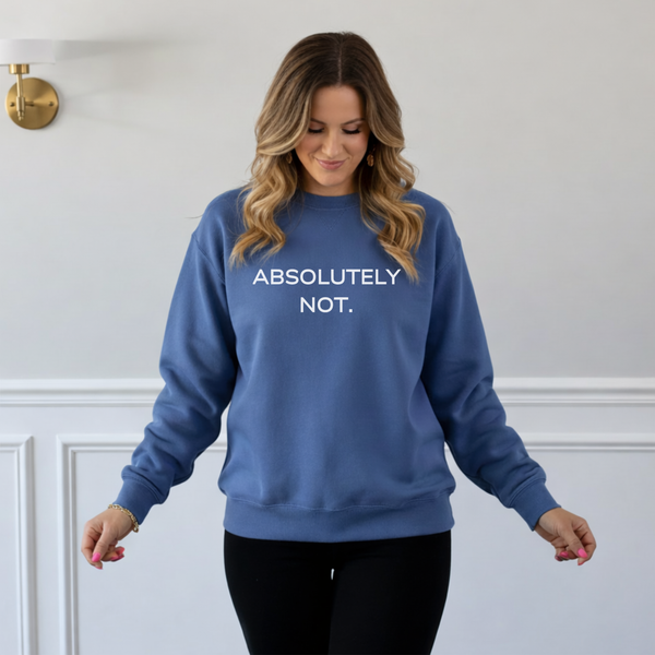Woman wearing a blue sweatshirt with 'ABSOLUTELY NOT.' text against a white wall.