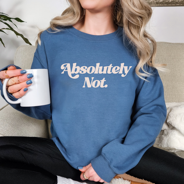 Person wearing a blue sweatshirt with 'Absolutely Not.' text, holding a white mug.