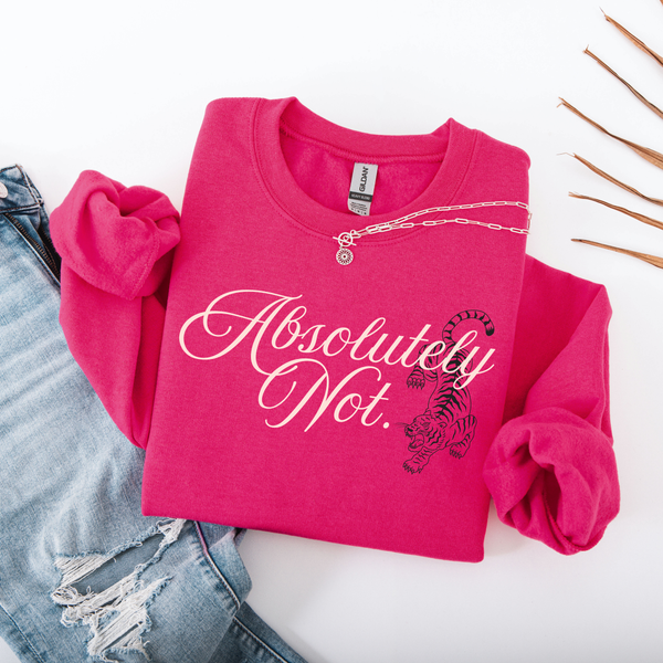 A folded hot pink sweatshirt with rolled sleeves, featuring the text 'Absolutely Not.' in white script and a black tiger graphic.