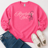 A bright pink crewneck sweatshirt laid flat on a white background, styled with blue jeans and white sneakers. The sweatshirt features the text 'Absolutely Not.