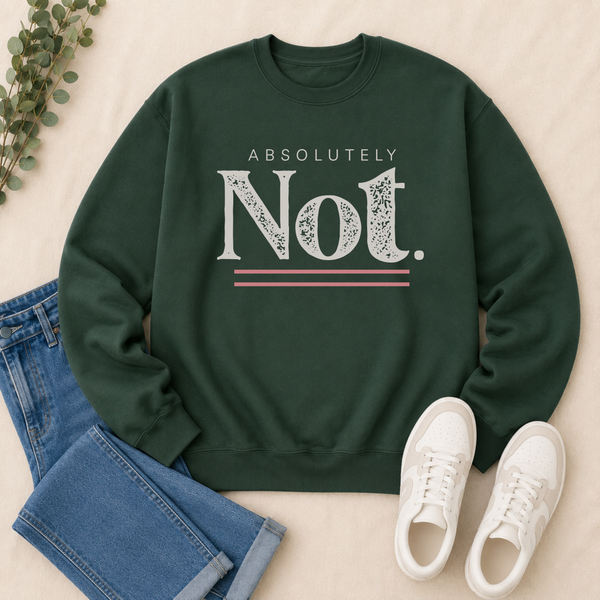A dark green crewneck sweatshirt with a distressed white graphic reading 'ABSOLUTELY Not.' and thin pink-red accent lines, styled in a flat lay with blue jeans, white sneakers, and a small green plant on a light beige fabric background.