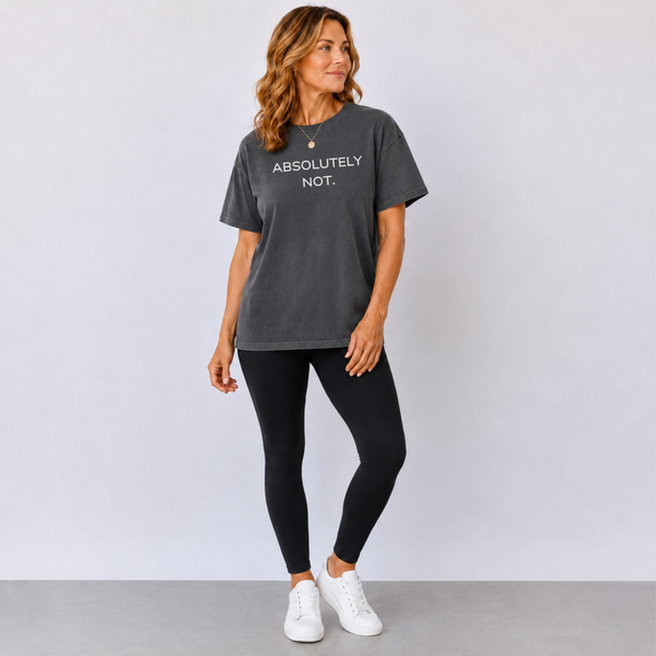 A woman standing in a faded black t-shirt that says "Absolutely Not"