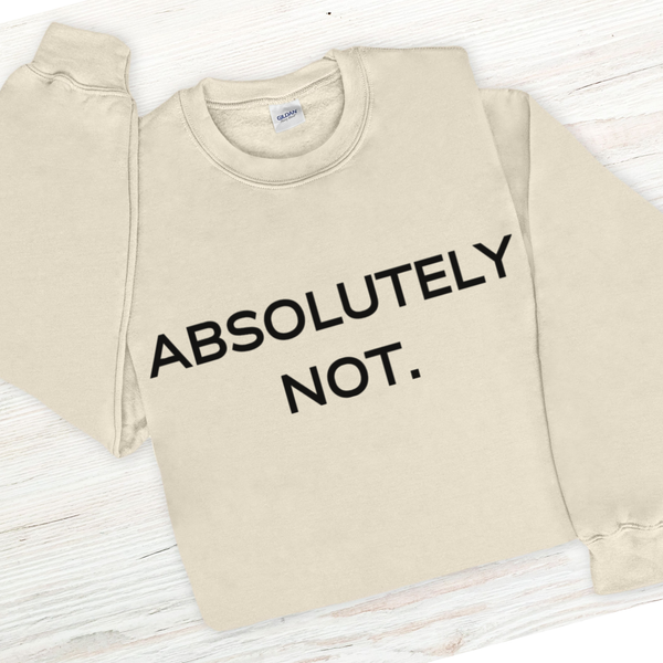 Beige sweatshirt with 'ABSOLUTELY NOT.' text on a light wooden surface