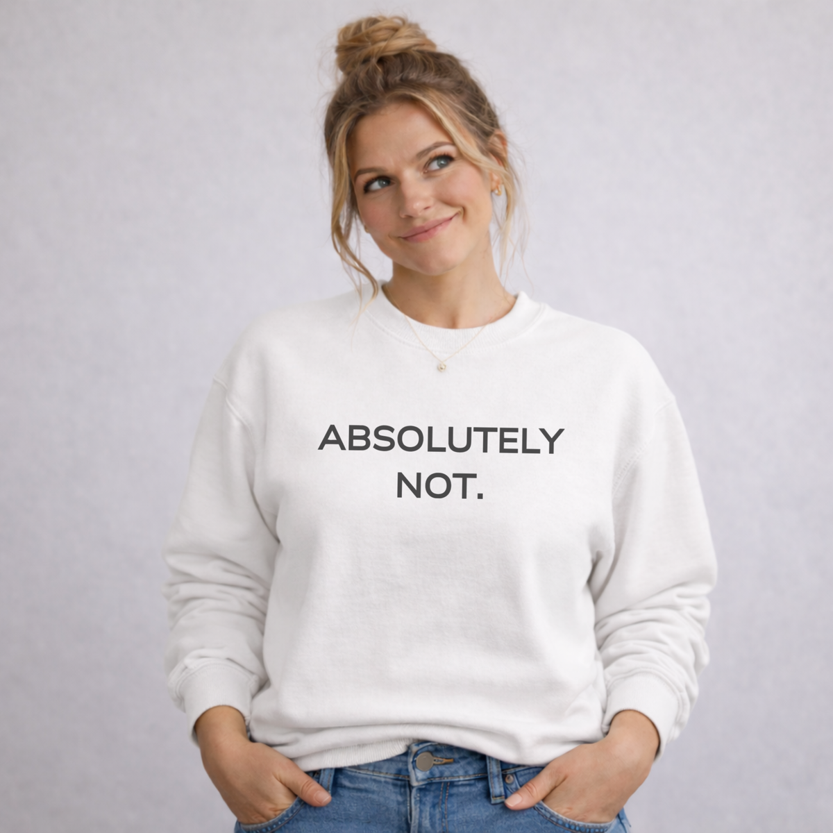Person wearing a white sweatshirt with 'ABSOLUTELY NOT.' text on a plain background