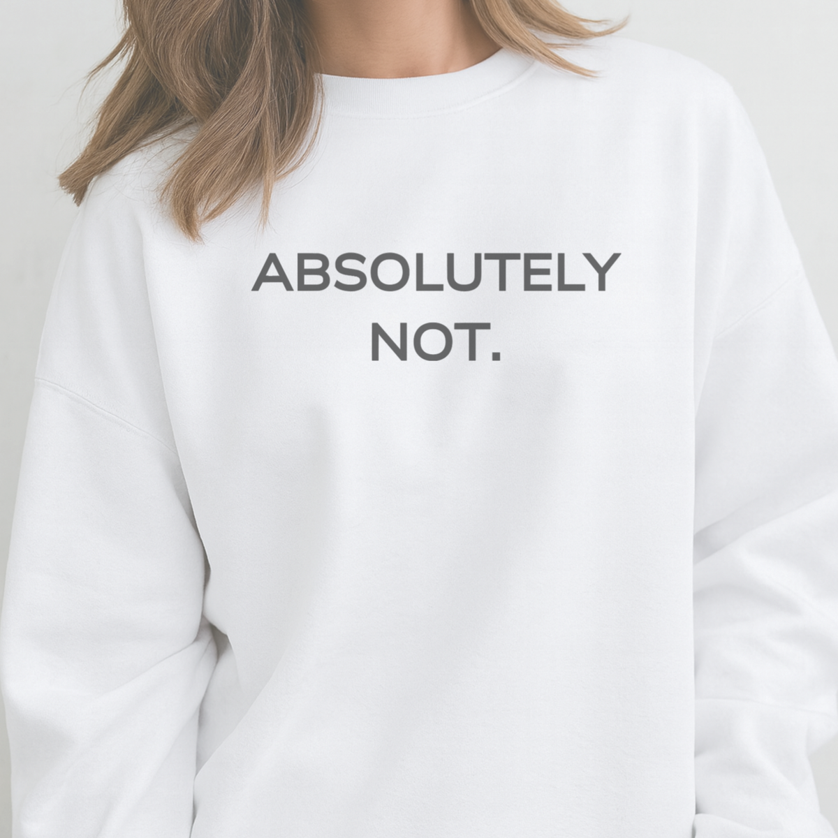 White sweatshirt with 'ABSOLUTELY NOT.' text on a plain background