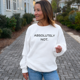 A woman wearing a white crewneck sweatshirt with the text 'ABSOLUTELY NOT.' printed in black across the chest, standing on a paved pathway outdoors.