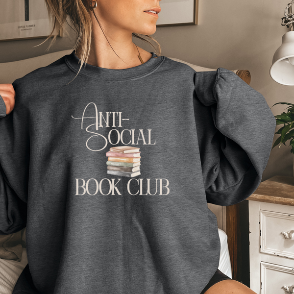 Person wearing a dark gray sweatshirt with 'Anti-Social Book Club' text and book illustrations.