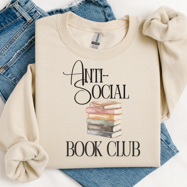 Beige sweatshirt with 'Anti-Social Book Club' text and book stack graphic on blue jeans.