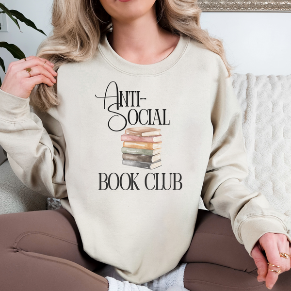 Person wearing a beige sweatshirt with 'Anti-Social Book Club' text and book graphic.