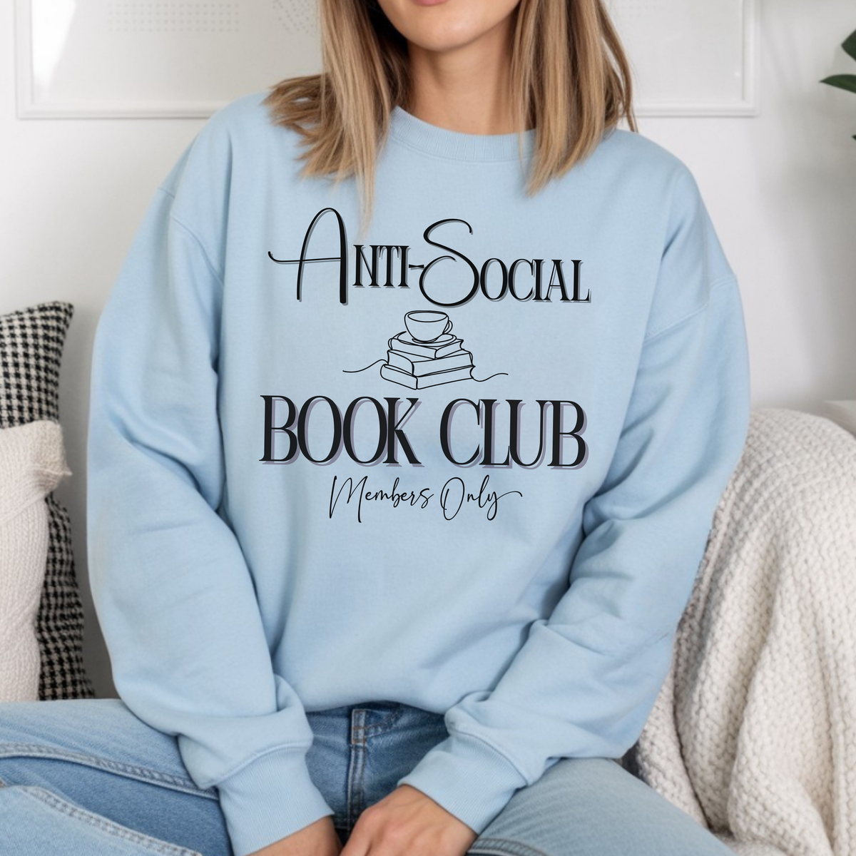 Person wearing a light blue sweatshirt with 'Anti-Social Book Club Members Only' text.
