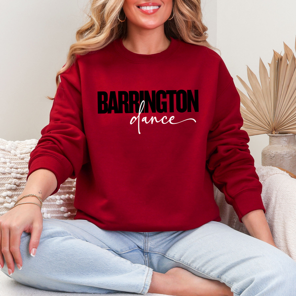 Person wearing a red sweatshirt with 'Barrington Dance' text, sitting on a couch.