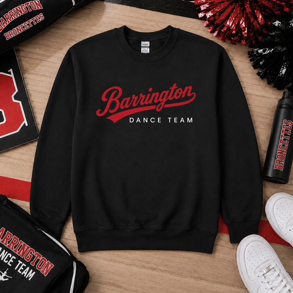 A black crewneck sweatshirt with 'Barrington Dance Team' printed in red and white across the chest, styled in a flat-lay arrangement on a wooden surface with team accessories and white sneakers.