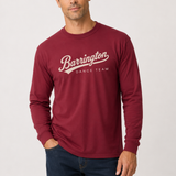 A man wearing a burgundy long-sleeve t-shirt with 'Barrington DANCE TEAM' printed in white script across the chest, paired with dark blue jeans, against a light gray studio background.