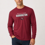A man wearing a maroon long-sleeve t-shirt with 'dance team BARRINGTON' and a horseshoe logo printed on the chest, paired with dark blue jeans against a light gray background.
