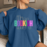 Person wearing an indigo blue sweatshirt with 'BOOKISH' text in colorful letters.