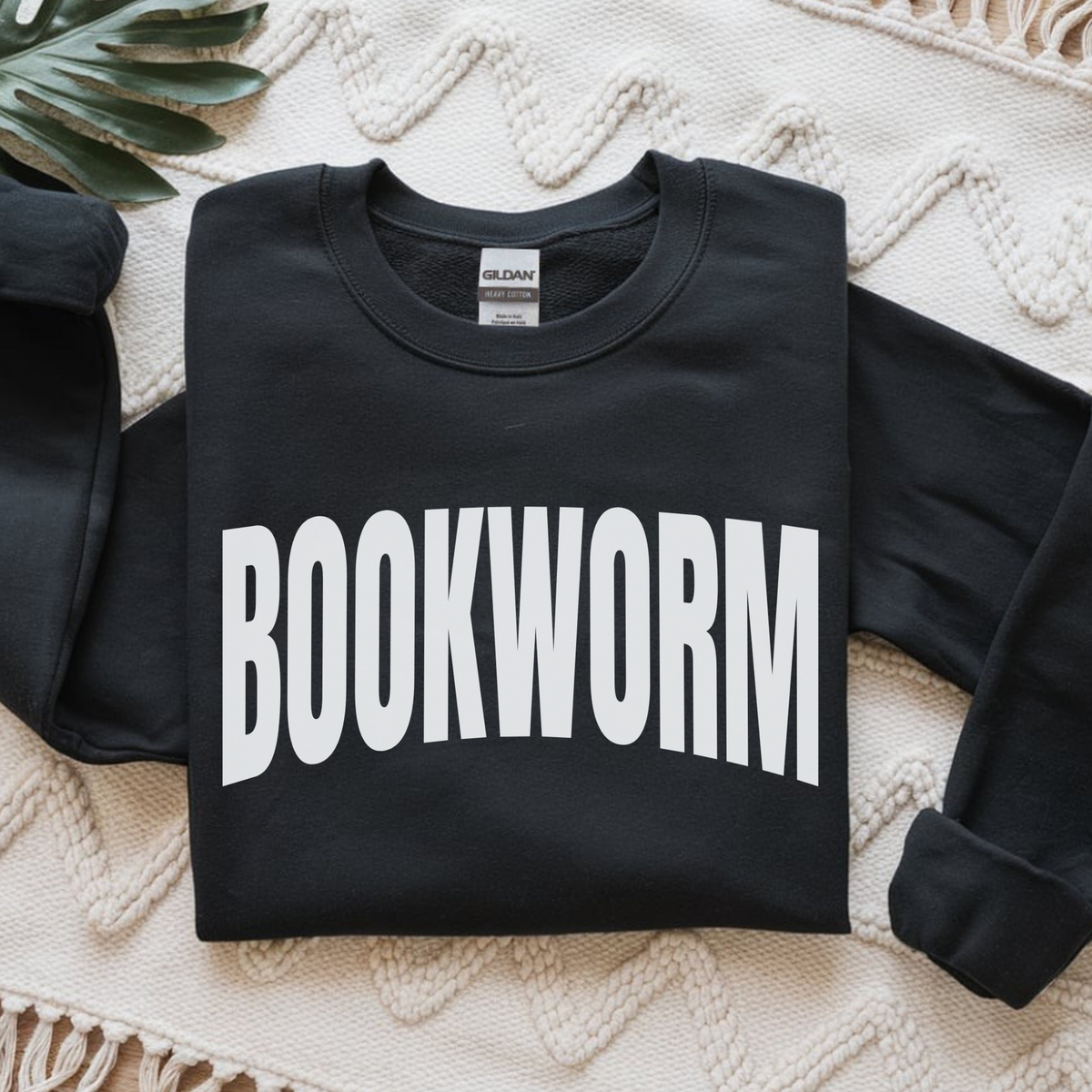 Black sweatshirt with 'BOOKWORM' text on a textured surface