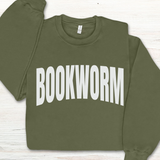 Green sweatshirt with 'BOOKWORM' text on a light wooden surface