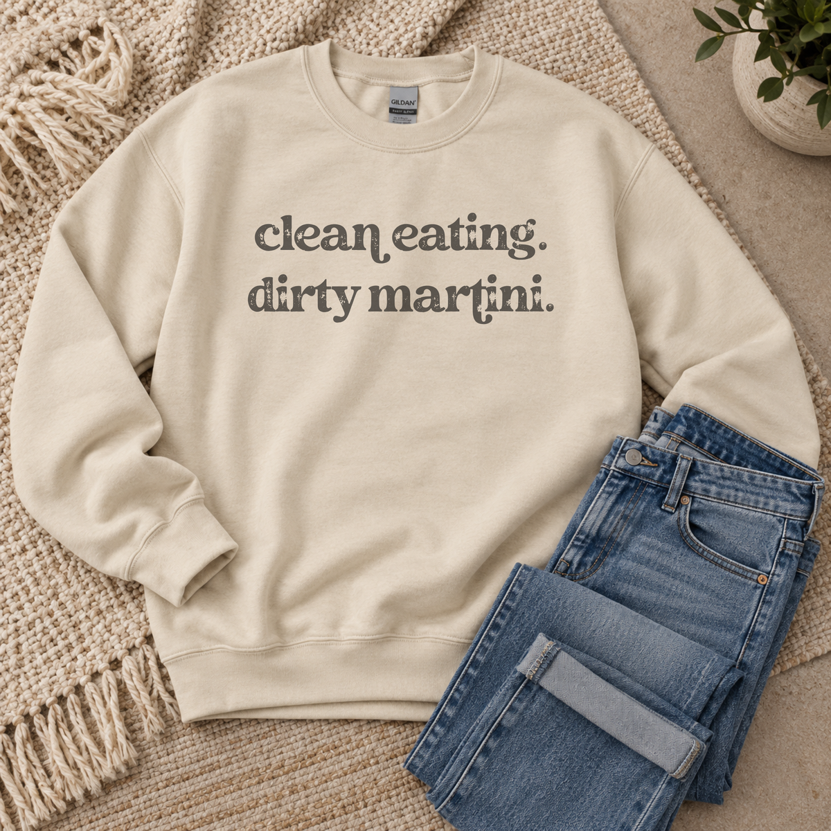 A cream-colored crewneck sweatshirt with the text 'clean eating. dirty martini.