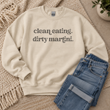 A cream-colored crewneck sweatshirt with the text 'clean eating. dirty martini.