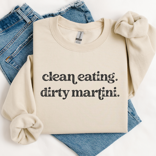 Beige sweatshirt with 'clean eating. dirty martini.' text on blue jeans
