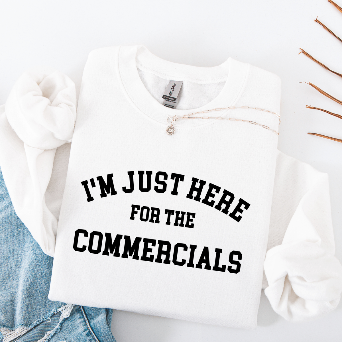 White sweatshirt with 'I'm just here for the commercials' text on a white background