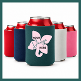A custom can cooler in dark teal shown in the foreground, with red, navy, white, and pink can coolers behind it on a white background. The front can cooler has a pink elephant graphic with the text 'YOUR Design HERE'.