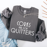 A folded charcoal gray sweatshirt with the words 