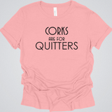 Pink t-shirt with 'Corks are for Quitters' text on a gray background