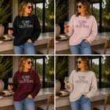 A four-panel collage showing a woman modeling the same slogan sweatshirt in four color options: black, light pink, burgundy, and light gray. She is wearing sunglasses, jeans, and holding wine glasses in an outdoor patio setting.