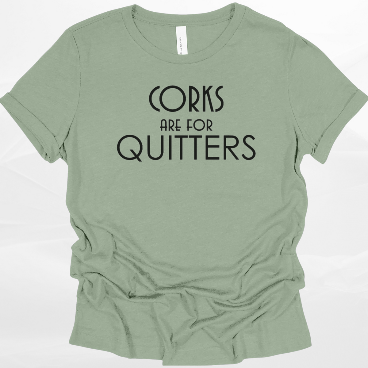 Sage green t-shirt with 'Corks are for Quitters' text on a white background