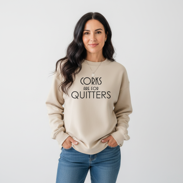 Woman wearing a beige sweatshirt with text 'Corks are for Quitters' on a white background