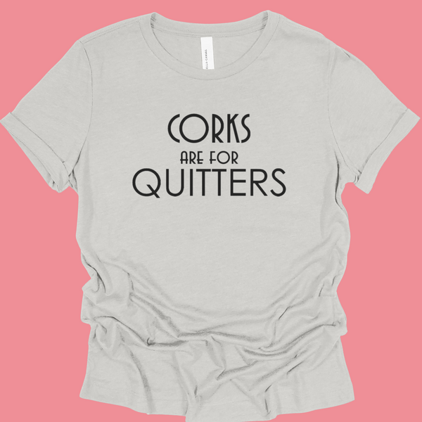 Light Gray t-shirt with 'Corks are for Quitters' text on a pink background