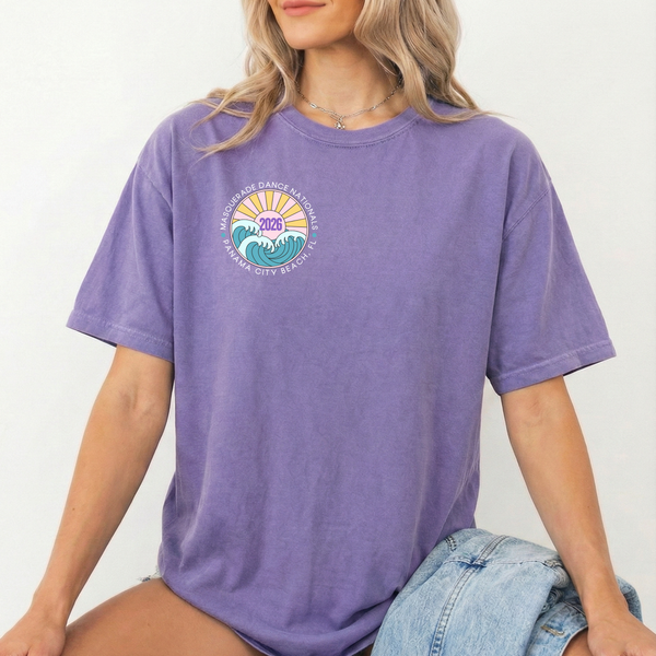 A woman in a purple shirt with a front design on the pocket