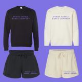 Black and beige sweatshirts and shorts with 'Denise Sabala Dance Company' text on a purple background