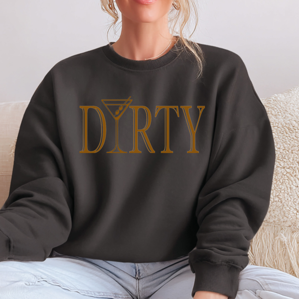 Person wearing a black sweatshirt with 'DIRTY' printed in gold on a light background. The letter "i" in 'martini' is a martini glass.