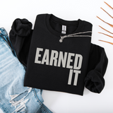 A folded black sweatshirt with the words 