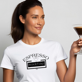 Woman in a white T-shirt holding an espresso martini with the words 