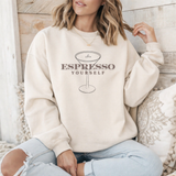 Person wearing a beige sweatshirt with 'Espresso Yourself' text and espresso martini graphic.
