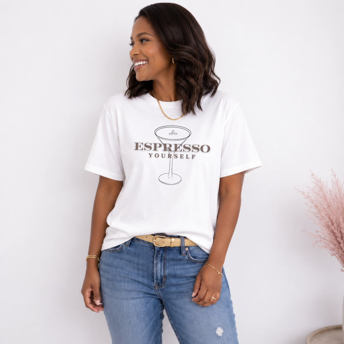 Woman wearing a white t-shirt with 'Espresso Yourself' design against a plain background