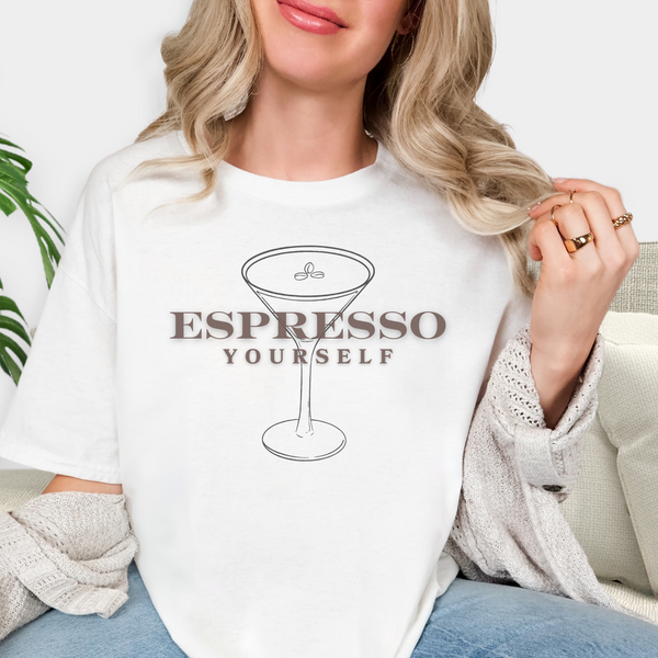 Person wearing a white sweatshirt with 'Espresso Yourself' text and martini glass design.
