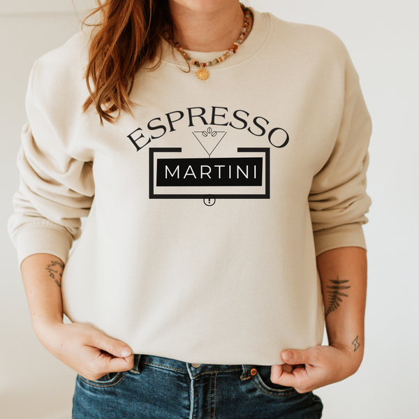 Person wearing a beige sweatshirt with 'Espresso Martini' text design.