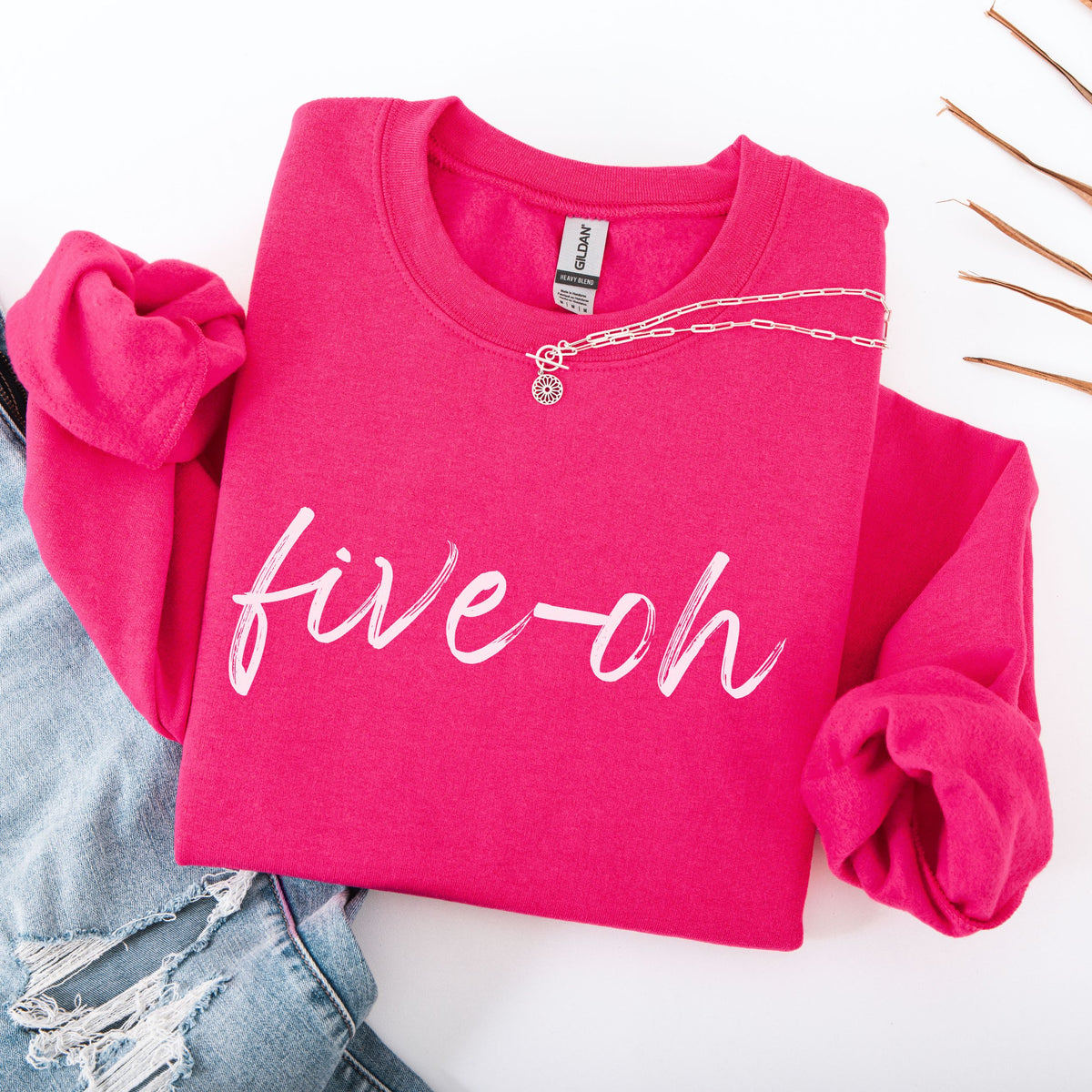 Pink sweatshirt with 'five-oh' text on a white background