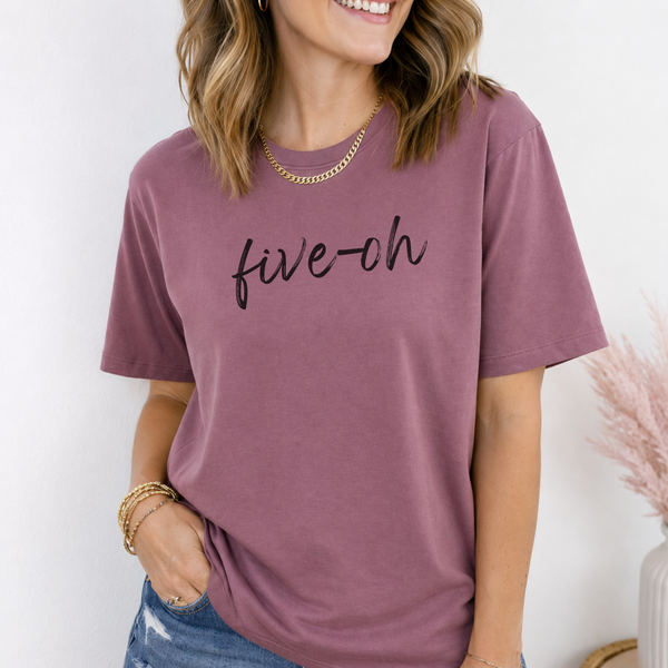 Person wearing a mauve t-shirt with 'five-oh' text on a white background