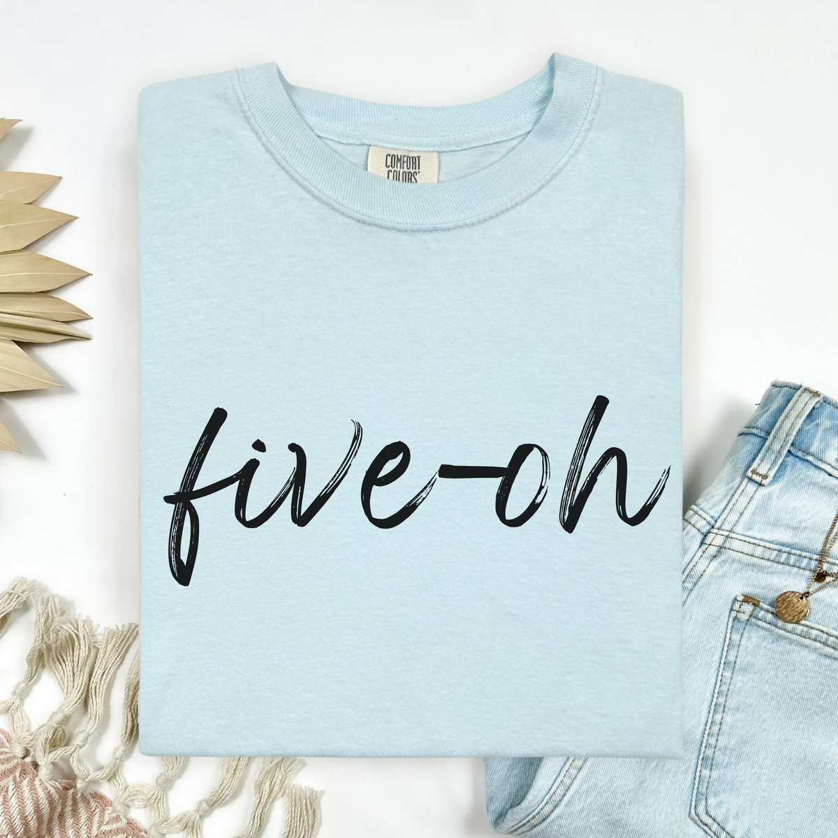 Light blue tee shirt with 'five oh' text on a white background