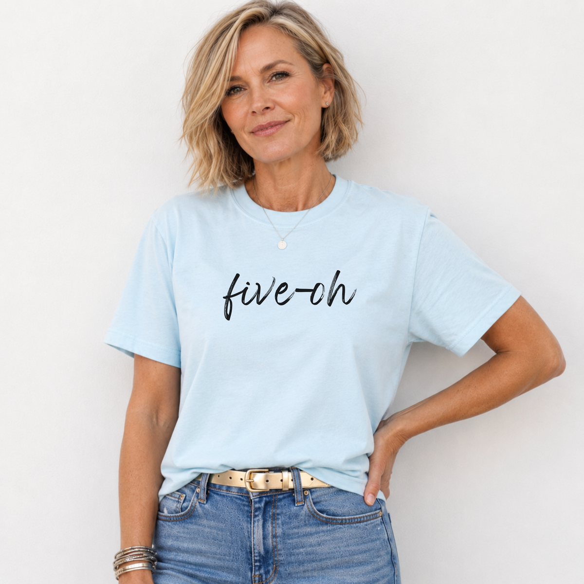 Woman wearing a light blue t-shirt with 'five-ch' text on a plain background